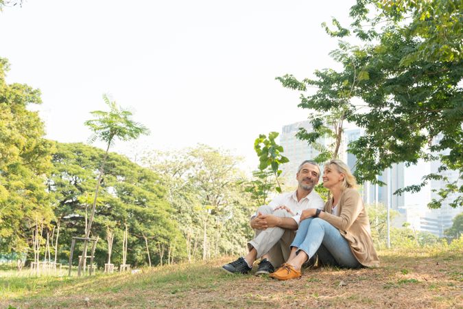 Calm mature man and woman relaxing in park