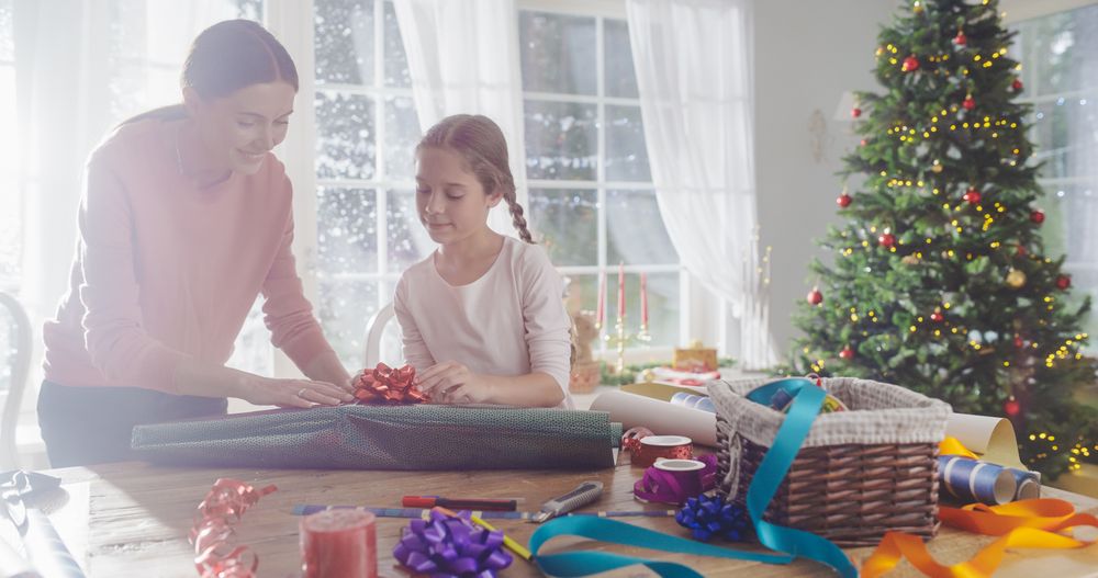 Cute Little Girl Choosing Decorations for Gift Boxes to Give to Family, Holiday Season Full of Love and Sharing