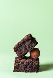 Two brownies stack on a hazelnut