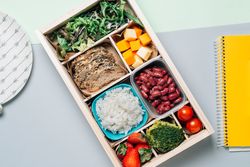 Food box with diet ingredients by copybook and plate
