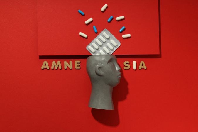 Bust with pills and the words “Amnesia”