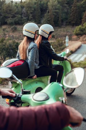 Young people riding motorcycles on city road