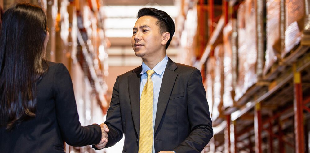 Banner of Asian professional male shaking hands of female colleague
