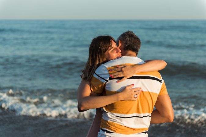 Adult couple embracing near sea