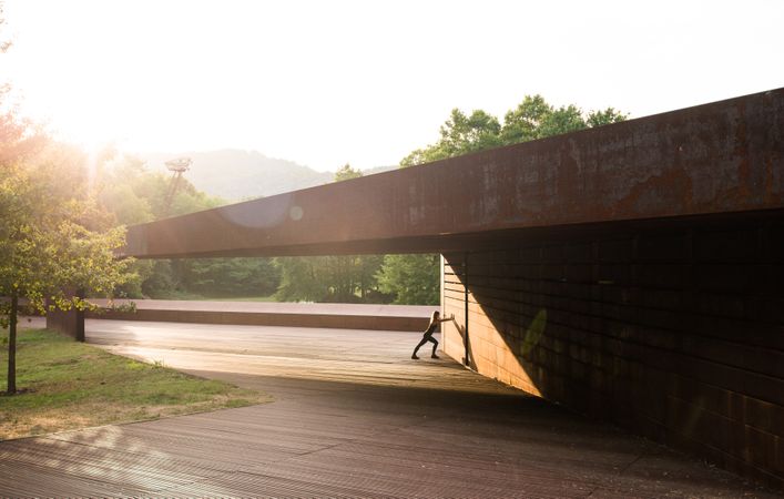 young woman stretching leaning in a amazing geometrical building