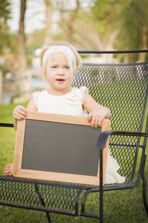 Cute Baby Girl in Chair Holding Board
