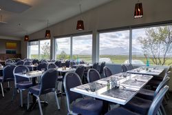 Dinning room with wonderful view of summer mountain landscape from window in hotel