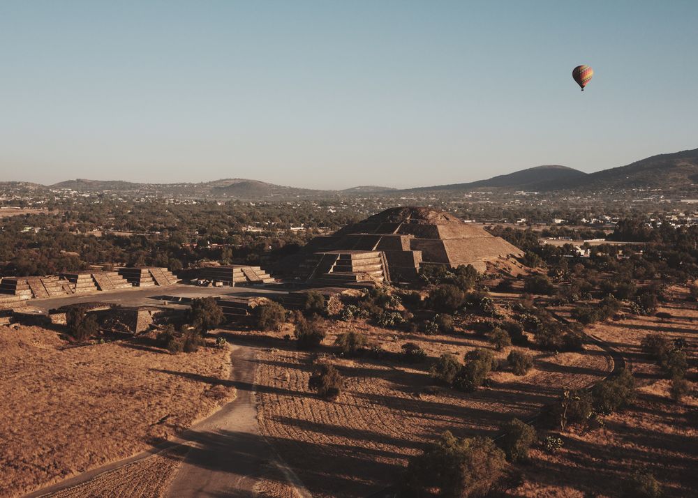 One hot air balloon in flight over pyramids in Teotihuacan Valley