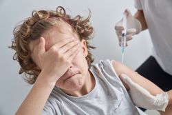 Anonymous medic injecting scared child