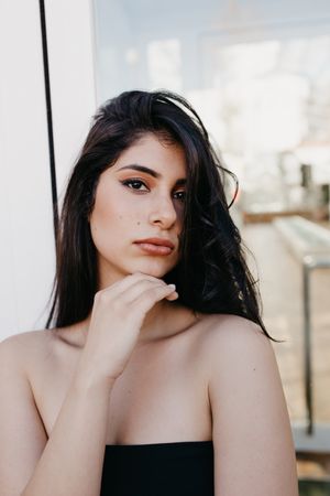 Woman posing near window