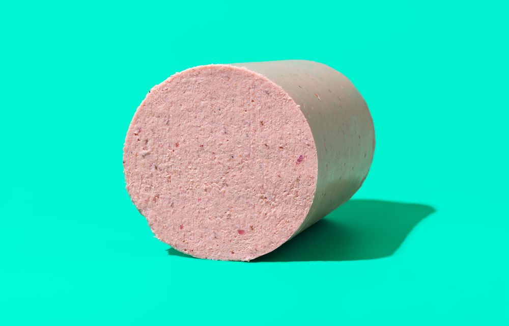 Homemade baloney isolated on a green background