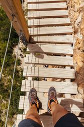 Man crossing a wooden bridge
