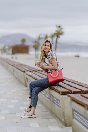 Young woman sitting on bench