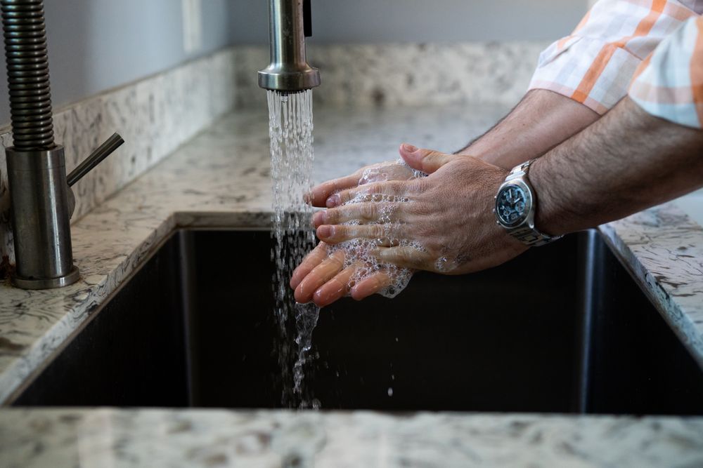 Man’s hands washing with soap in the sink