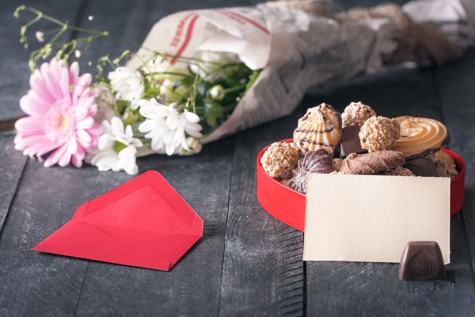 Blank message card, flowers and  and box with cookies for Valentine’s Day
