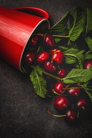 Cherry with branches in cup on table