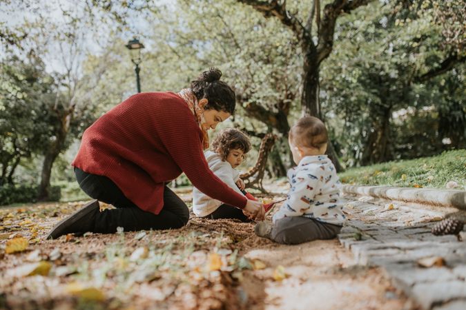 Mother in a park with her two children on an autumn day