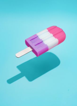 Colorful ice cream popsicle on bright blue background