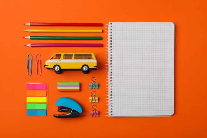 Flat lay with school supplies on orange background