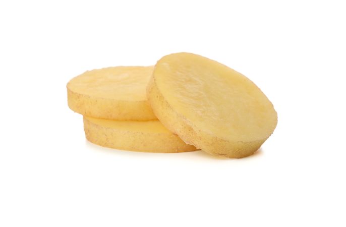 Three potato slices piled in bright room