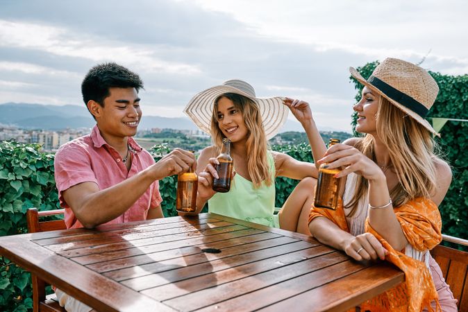a group of young people having a good time in a summer day and cheering with beer