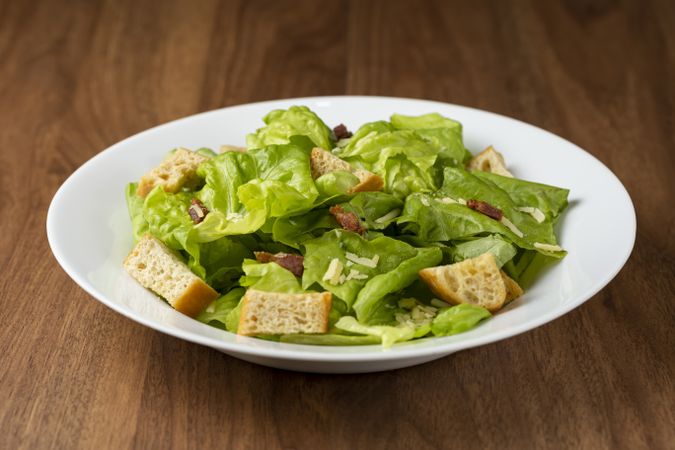 Caesar salad with croutons and bacon.