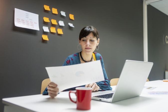 Smiling businesswoman working with documents