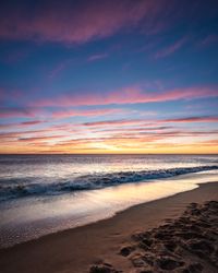 Calm waves on shore during golden hour