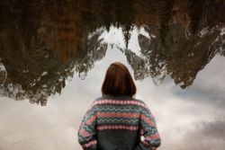 Woman delighting in views near lake and mountains