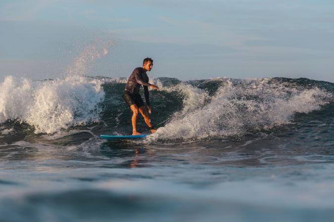 Man on surf board on waving water