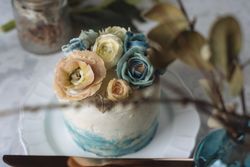 Buttercream flowers cake, blue and pastel peach colors