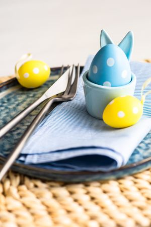 Easter holiday concept with dotted pastel Easter eggs decorating a table setting