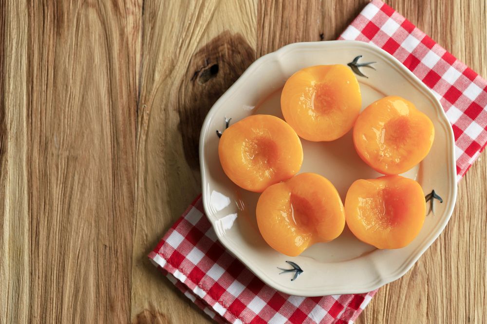 Top view of plate of tinned peaches on table