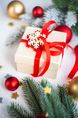 Marble counter with Christmas present wrapped with red ribbon