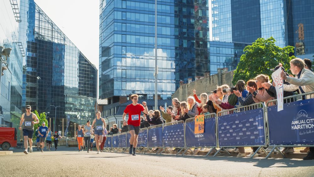 Diverse Group of People Competing in a Marathon Race in the City.