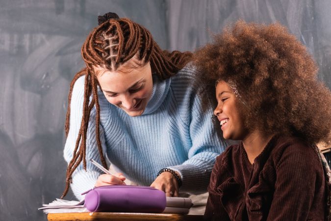Black schoolgirl and teacher in classroom