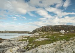 Northern landscape with rocky hills and rural houses