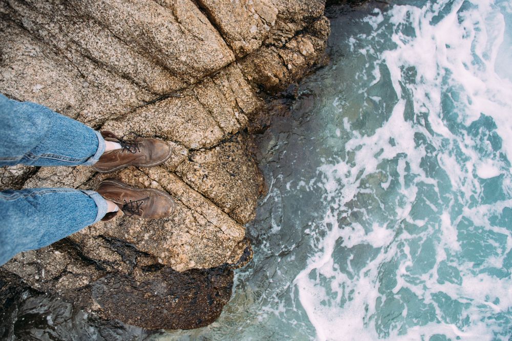 Leather boots on rocks near the coast