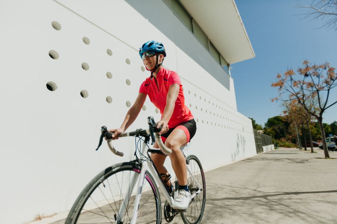 Sportswoman riding bicycle on street