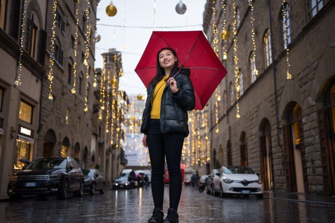 Cheerful Asian traveler exploring old street