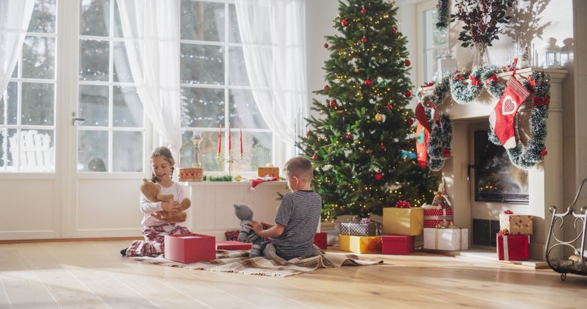 Cute Kids in Pajamas Getting Their Gifts On Christmas Bright Morning.