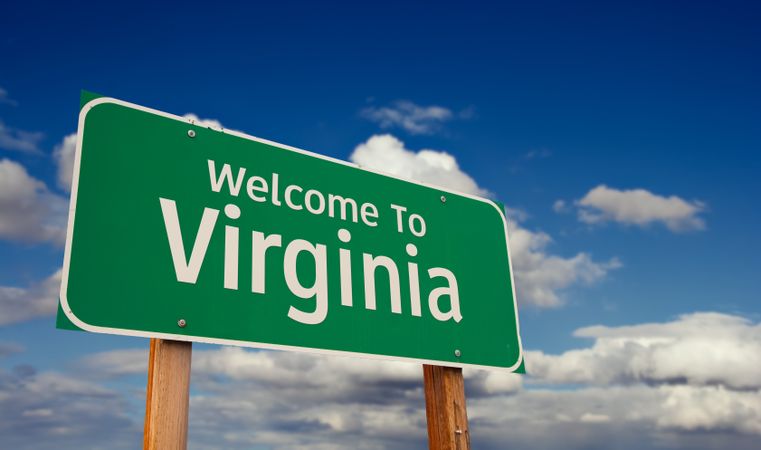 Welcome To Virginia Green Road Sign Over Blue Sky with Some Clouds.