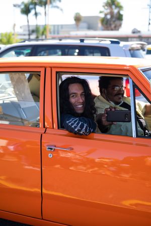 Los Angeles, CA, USA — June 7th, 2020: man looking out of vintage car at protest