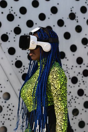 Black woman in VR headset in city