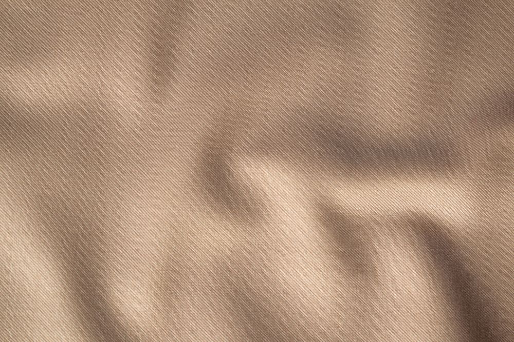Wavy smooth pattern brown fabric background texture.
