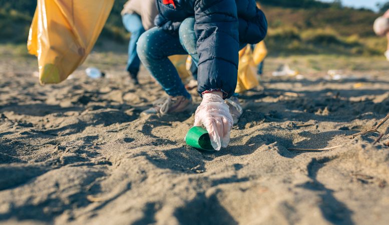 Little girl cleaning the beach