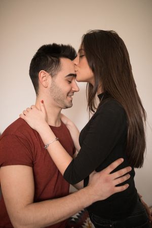 Couple sitting near fireplace on floor