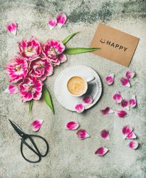 Lovely morning coffee beside fuschia flowers on concrete countertop