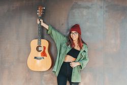Woman in glasses leaning on wall