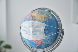 Medical mask placed on globe